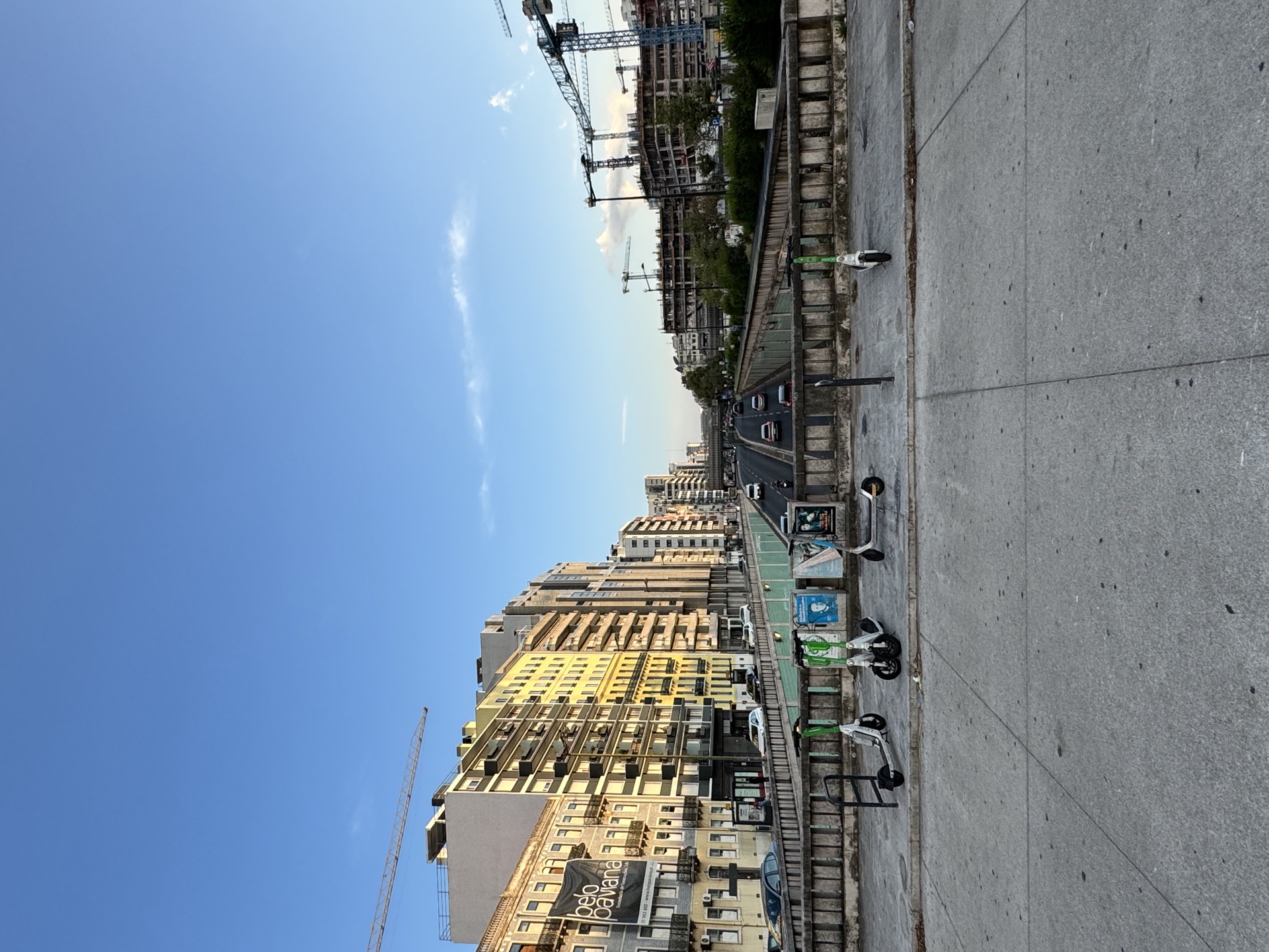 City avenue near EntreCampos with cranes in the background