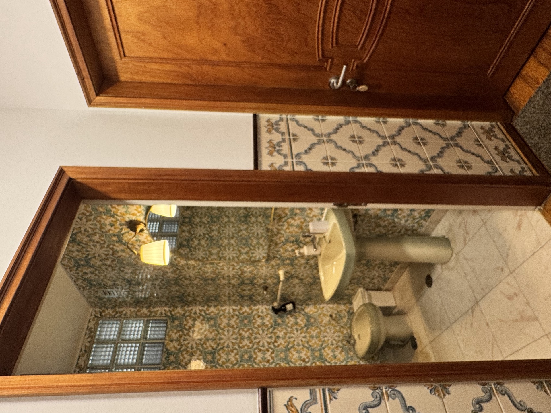 Vintage tiled bathroom with pedestal sink and bidet
